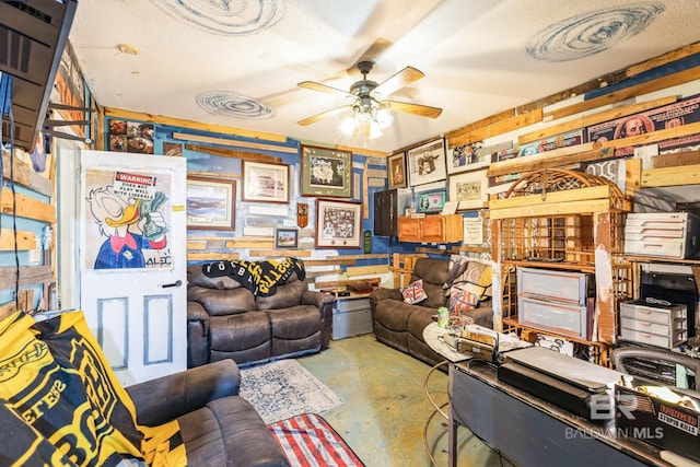 office space featuring ceiling fan, a textured ceiling, and concrete floors