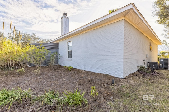 view of side of property with central AC unit