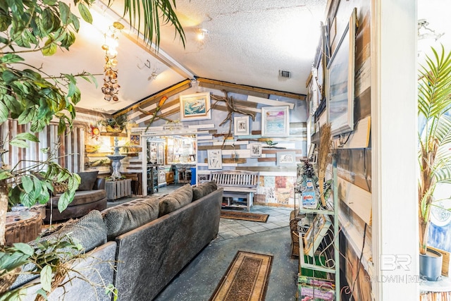 living room with a textured ceiling and lofted ceiling