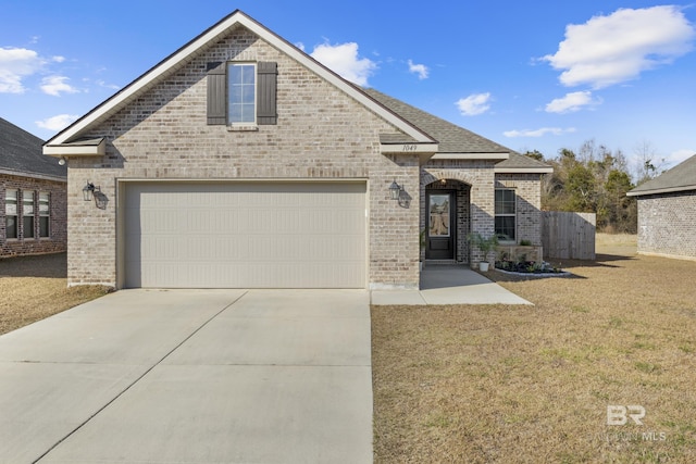 view of front of house featuring a garage and a front yard