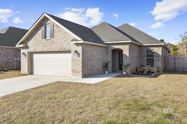 view of front of home featuring a garage and a front lawn