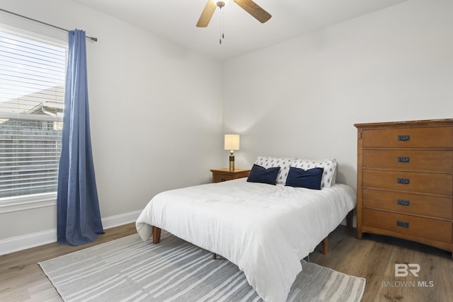 bedroom with ceiling fan and wood-type flooring