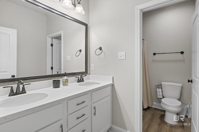 bathroom with a shower with curtain, vanity, hardwood / wood-style floors, and toilet