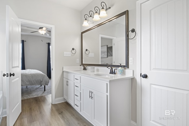 bathroom featuring vanity, hardwood / wood-style floors, and ceiling fan