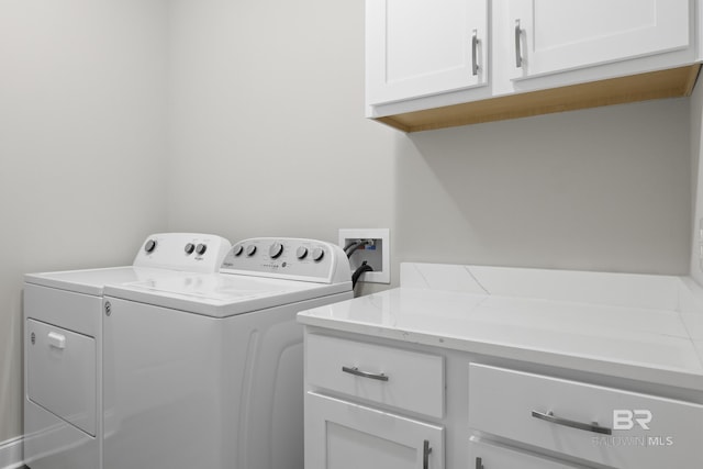 washroom with cabinets and independent washer and dryer