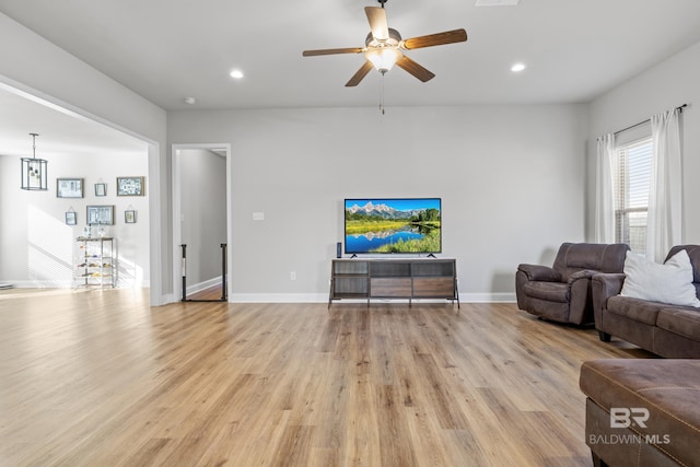 living room with ceiling fan and light wood-type flooring