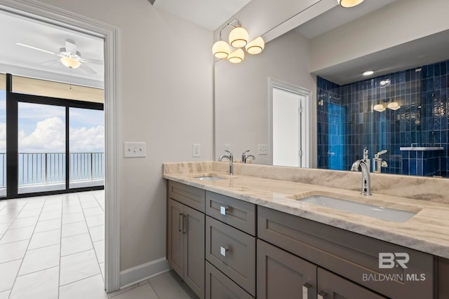 533 E Beach Blvd Unit 2403, Gulf Shores, AL 36542 - bathroom with double vanity, tile patterned floors, floor to ceiling windows, a ceiling fan, and tiled shower