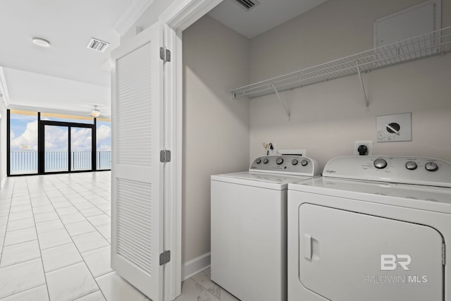 533 E Beach Blvd Unit 2403, Gulf Shores, AL 36542 - washroom featuring washing machine and dryer and light marble finish floors