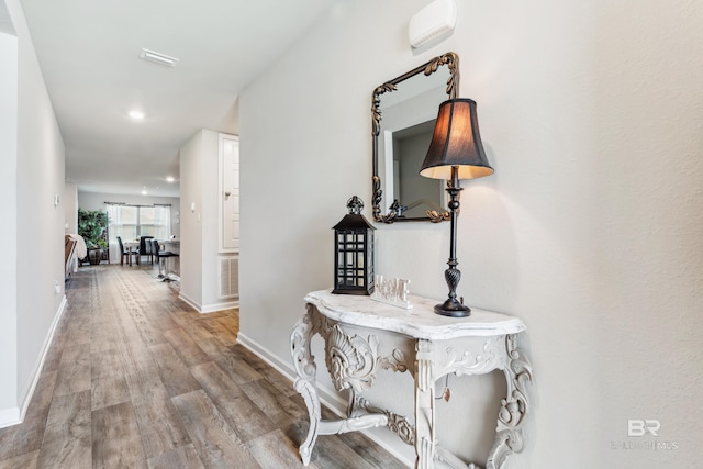 corridor with hardwood / wood-style floors