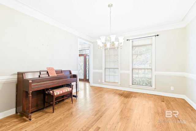 misc room with ornamental molding, a notable chandelier, and light hardwood / wood-style flooring