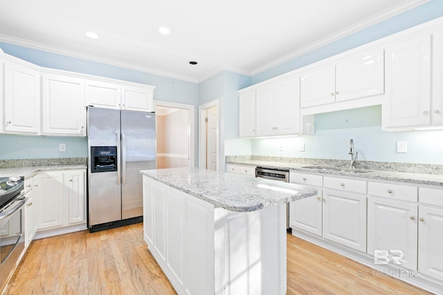 kitchen with stainless steel refrigerator with ice dispenser, a kitchen island, range, and white cabinets