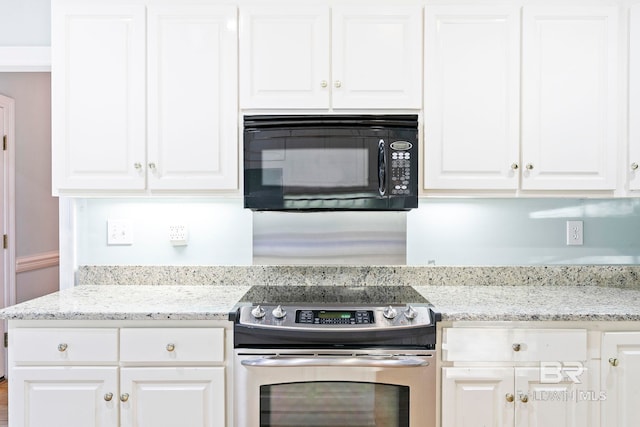 kitchen featuring white cabinetry, light stone counters, and stainless steel electric range