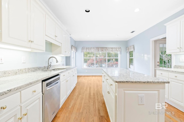 kitchen with white cabinetry, dishwasher, and a kitchen island