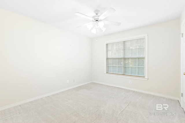 carpeted empty room featuring ceiling fan