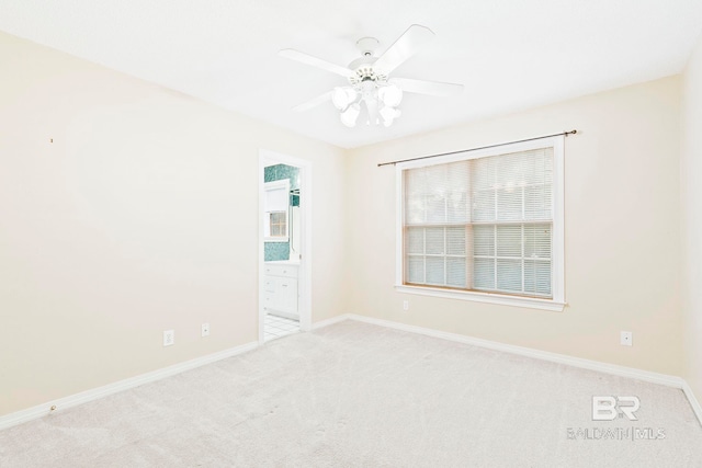 empty room featuring light colored carpet and ceiling fan