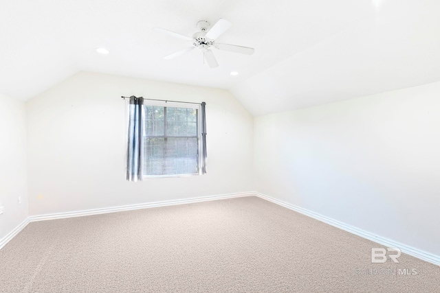 additional living space featuring carpet floors, ceiling fan, and vaulted ceiling