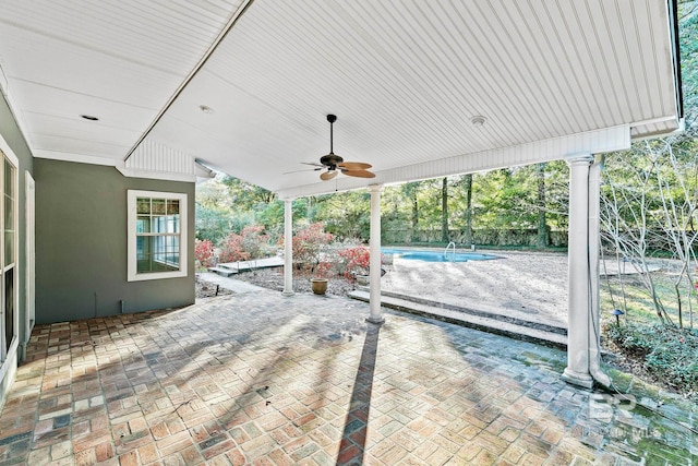 view of patio / terrace with a fenced in pool and ceiling fan