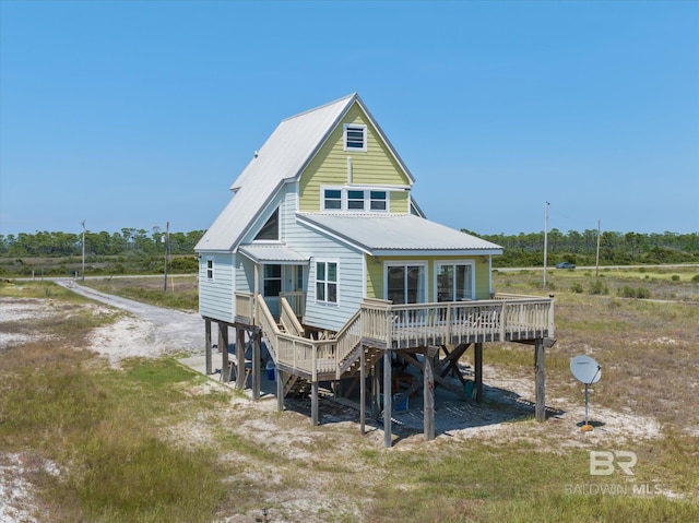 rear view of property featuring a wooden deck