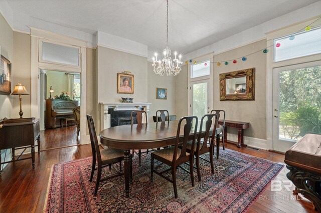 2550 Springhill Ave, Mobile, AL 36607 - dining area with a chandelier, baseboards, and hardwood / wood-style flooring