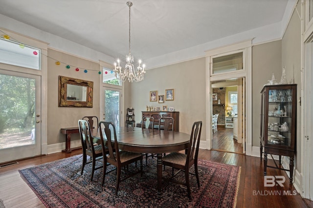 2550 Springhill Ave, Mobile, AL 36607 - dining space featuring hardwood / wood-style flooring, baseboards, a notable chandelier, and visible vents