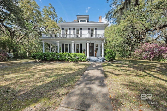 2550 Springhill Ave, Mobile, AL 36607 - italianate home featuring a porch, a front lawn, a balcony, and a chimney
