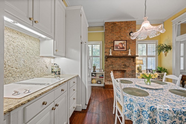 2550 Springhill Ave, Mobile, AL 36607 - kitchen with tasteful backsplash, white cabinetry, white electric cooktop, dark wood-type flooring, and ornamental molding