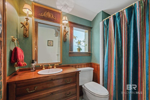 2550 Springhill Ave, Mobile, AL 36607 - bathroom featuring vanity, toilet, a wainscoted wall, and curtained shower