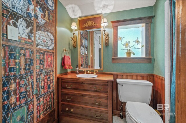 2550 Springhill Ave, Mobile, AL 36607 - full bathroom with vanity, toilet, and a wainscoted wall