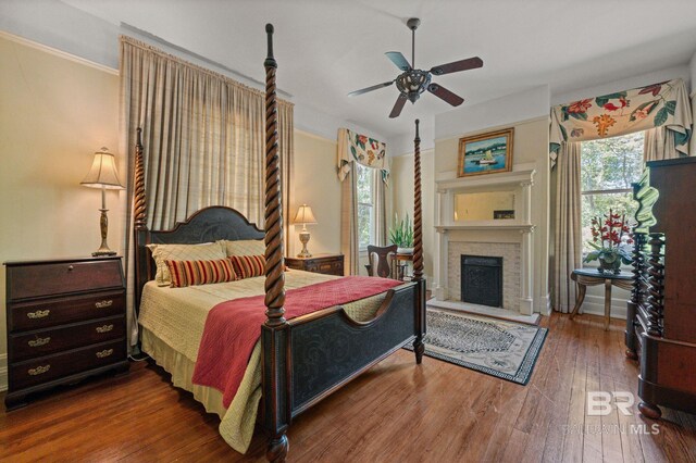 2550 Springhill Ave, Mobile, AL 36607 - bedroom with wood-type flooring, crown molding, a ceiling fan, and a fireplace