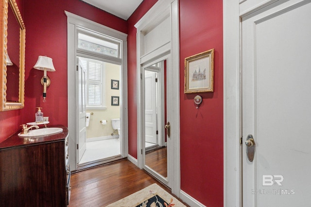 2550 Springhill Ave, Mobile, AL 36607 - doorway to outside with baseboards, dark wood-style flooring, and a sink