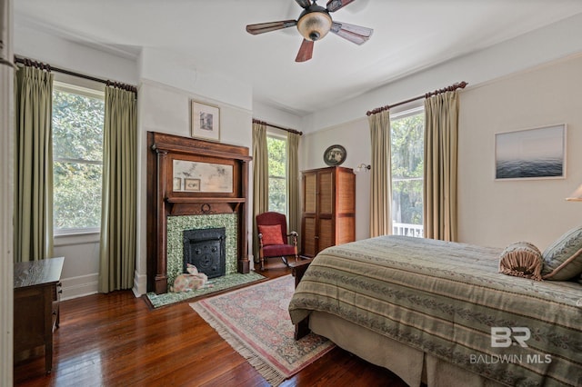 2550 Springhill Ave, Mobile, AL 36607 - bedroom with a tile fireplace, dark wood-style flooring, and multiple windows
