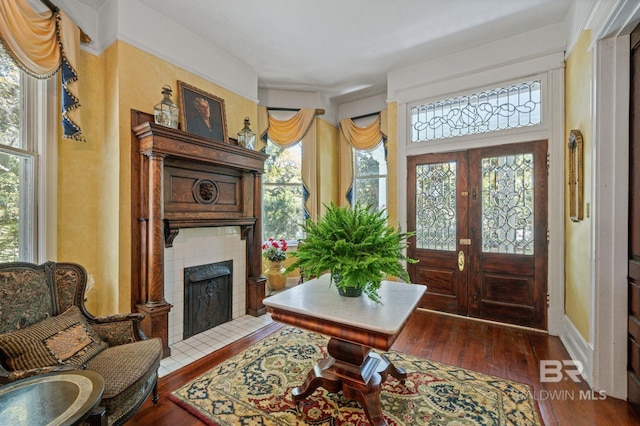 2550 Springhill Ave, Mobile, AL 36607 - foyer with a tiled fireplace and dark wood-style floors