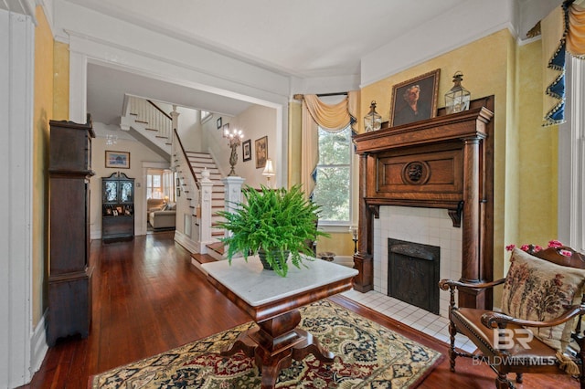 2550 Springhill Ave, Mobile, AL 36607 - sitting room with wood-type flooring, stairway, a tiled fireplace, and baseboards