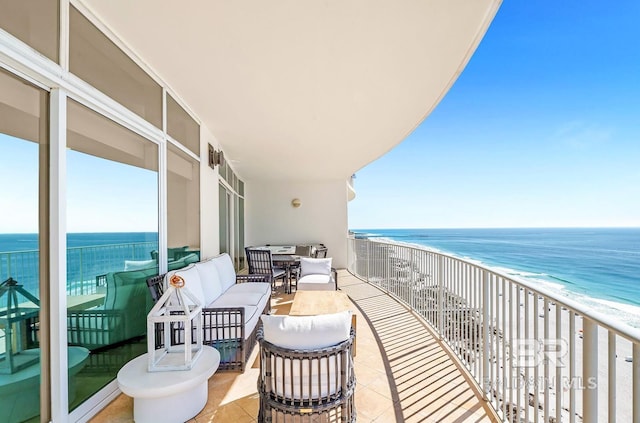 balcony with a water view and a beach view