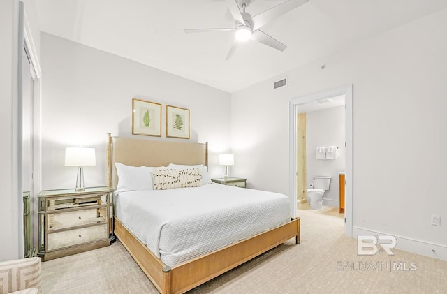 bedroom with ceiling fan, carpet flooring, and ensuite bath