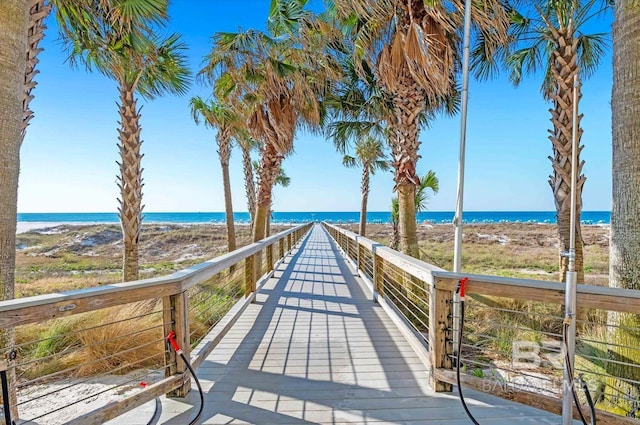 view of home's community featuring a water view and a beach view