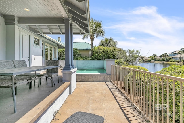 view of patio / terrace featuring a water view and outdoor dining area