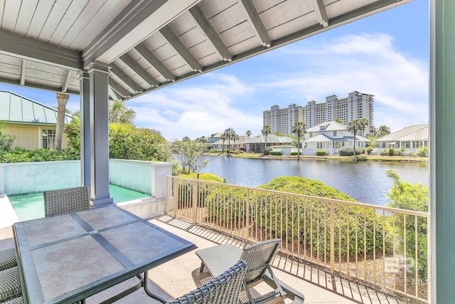 exterior space with a water view and outdoor dining area