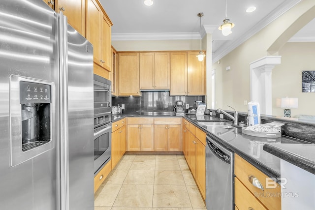 kitchen featuring ornamental molding, light brown cabinets, appliances with stainless steel finishes, and a sink