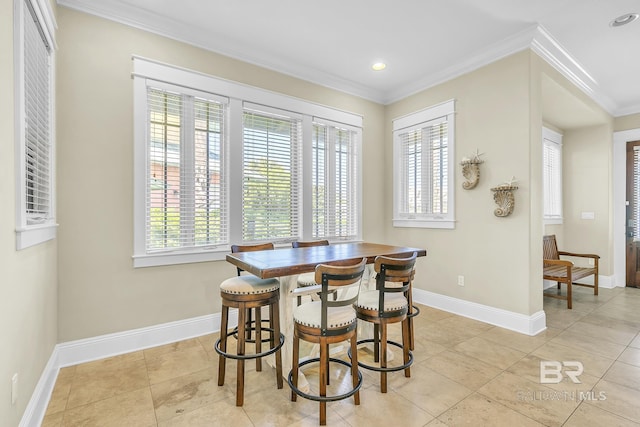 dining room featuring baseboards, recessed lighting, and crown molding