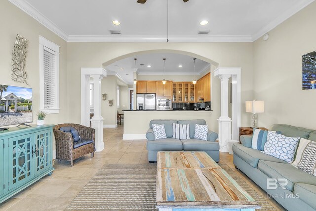 living area featuring visible vents, decorative columns, ceiling fan, and arched walkways