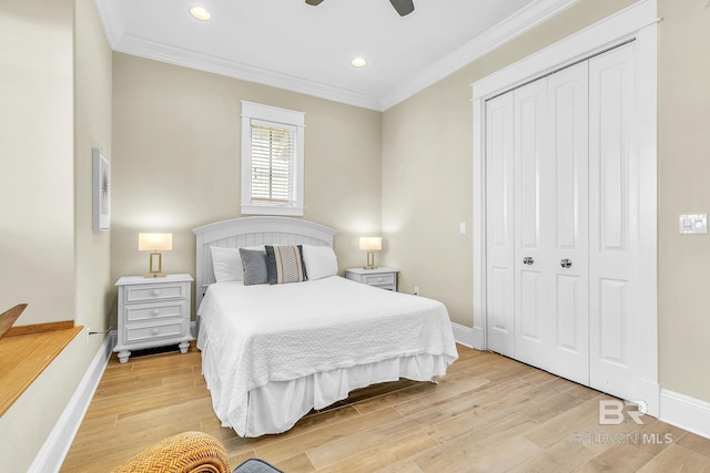 bedroom with light wood finished floors, a closet, baseboards, and ornamental molding
