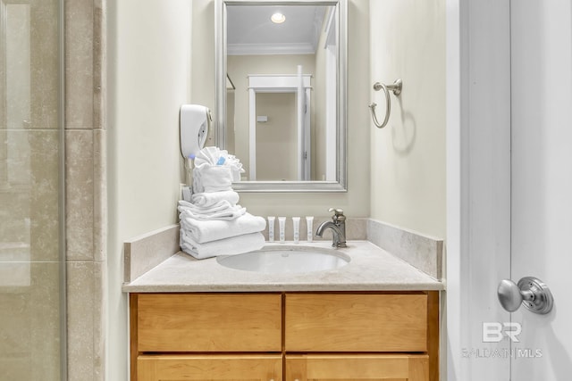 bathroom featuring ornamental molding and vanity