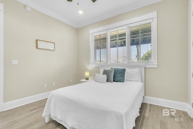 8620 Greenwich Ct Unit Cottage 9, Gulf Shores, AL 36542 - bedroom with ornamental molding, baseboards, a ceiling fan, and wood finished floors