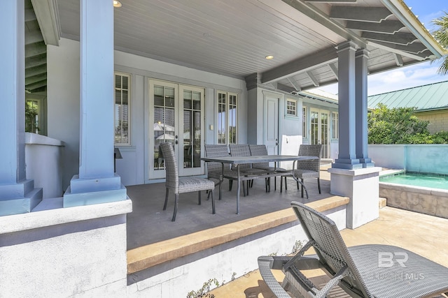 view of patio / terrace with outdoor dining area, a fenced in pool, and french doors