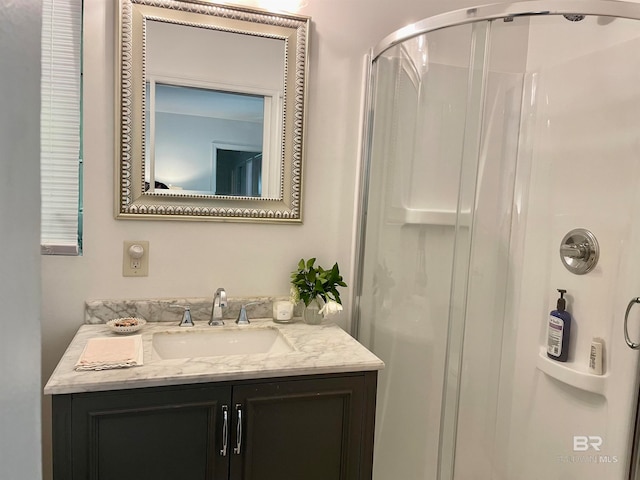 bathroom featuring vanity and a shower with shower door