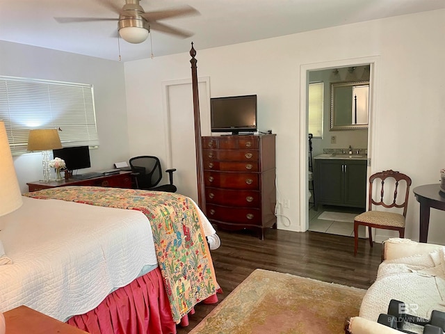 bedroom featuring dark wood-type flooring, ceiling fan, connected bathroom, and sink