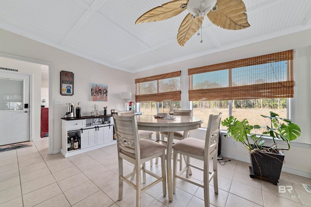 dining space with light tile patterned floors, visible vents, a ceiling fan, and baseboards
