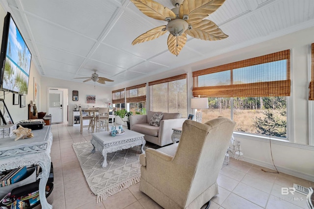 sunroom / solarium with a healthy amount of sunlight, ceiling fan, and visible vents