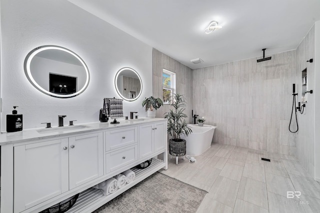 full bath featuring double vanity, a soaking tub, a walk in shower, and a sink